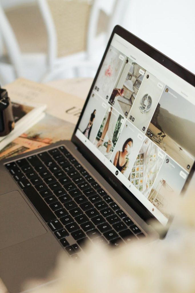 images-on-laptop-screen-17580690 Open laptop showing an image gallery on a wooden table, perfect for technology and workspace themes.