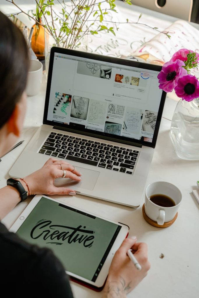 Créativité numérique Creative work session featuring a woman using a tablet and laptop for design projects.